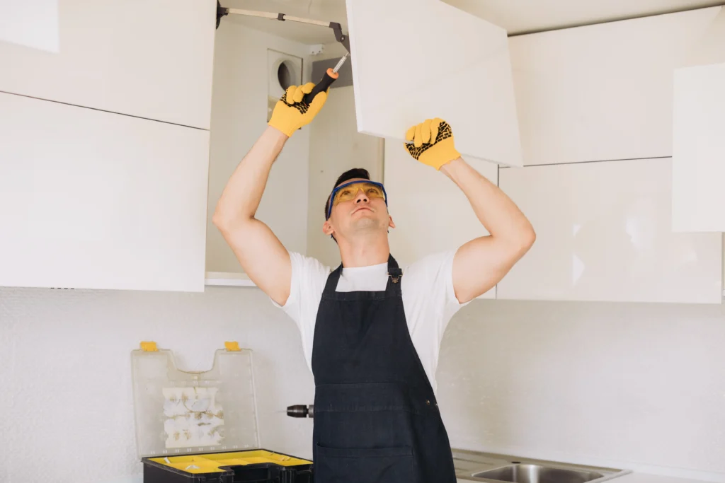 A man Repairing his Kitchen Cabinet