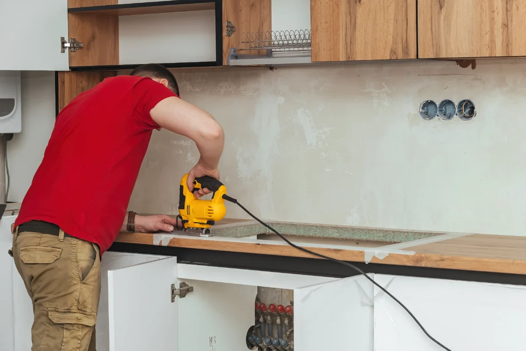 A man installing a kitchen countertop